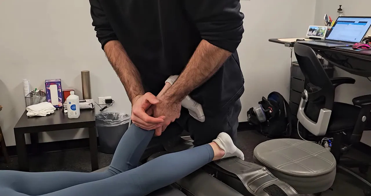 Dr. Durnas working through a patient's lower leg and ankle