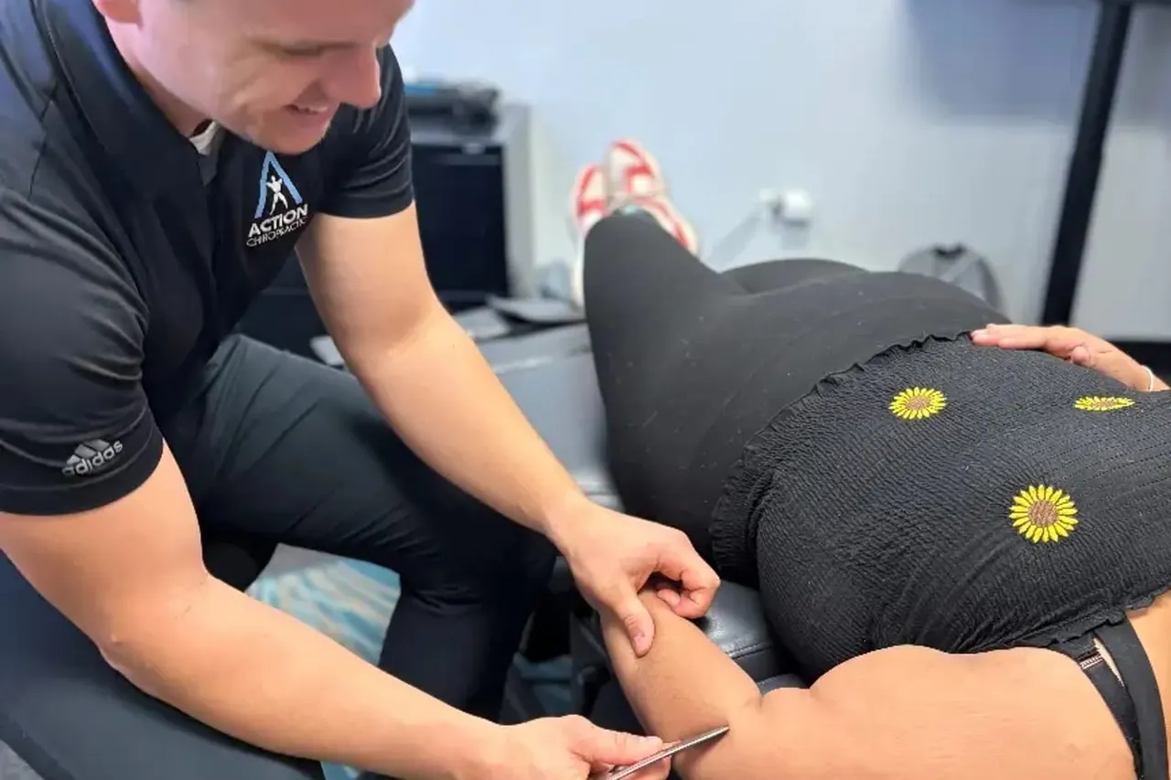 Hands-on soft tissue treatment through a patient's hip and hamstring