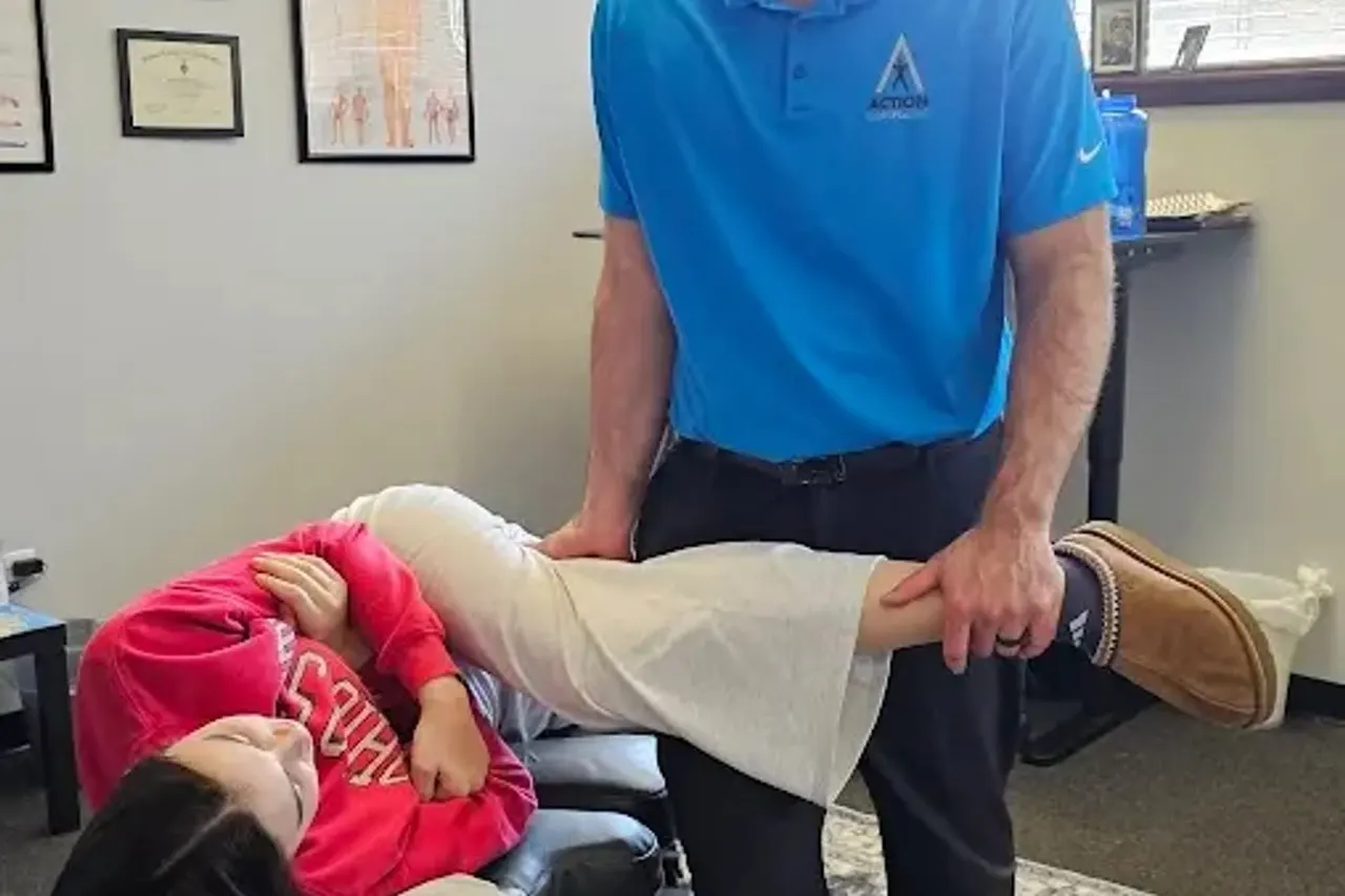 A doctor moving a patient's leg through its range