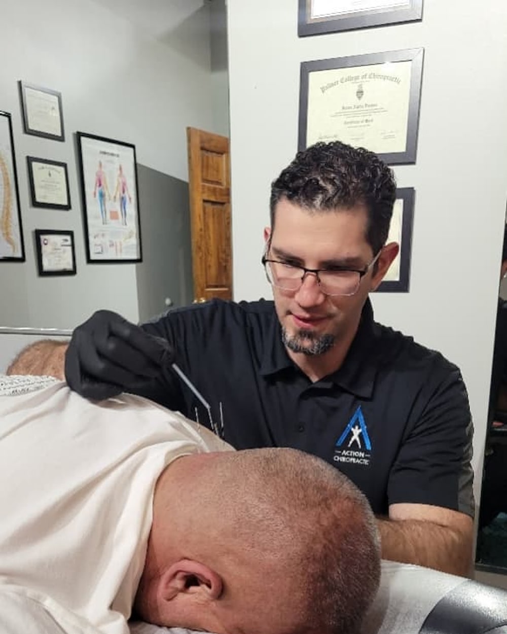 Dr. Jason Durnas treating a patient at Action Chiropractic and Sports Injury Center